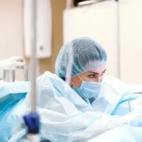 A focused plastic surgeon concentrating during a procedure