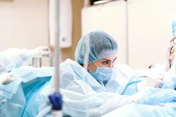 A focused plastic surgeon concentrating during a procedure