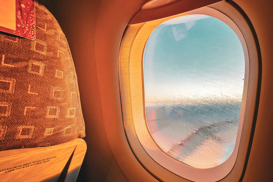 Warm sunlight through an airplane window during a flight