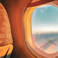 Warm sunlight through an airplane window during a flight