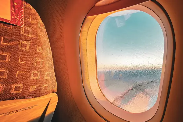 Warm sunlight through an airplane window during a flight